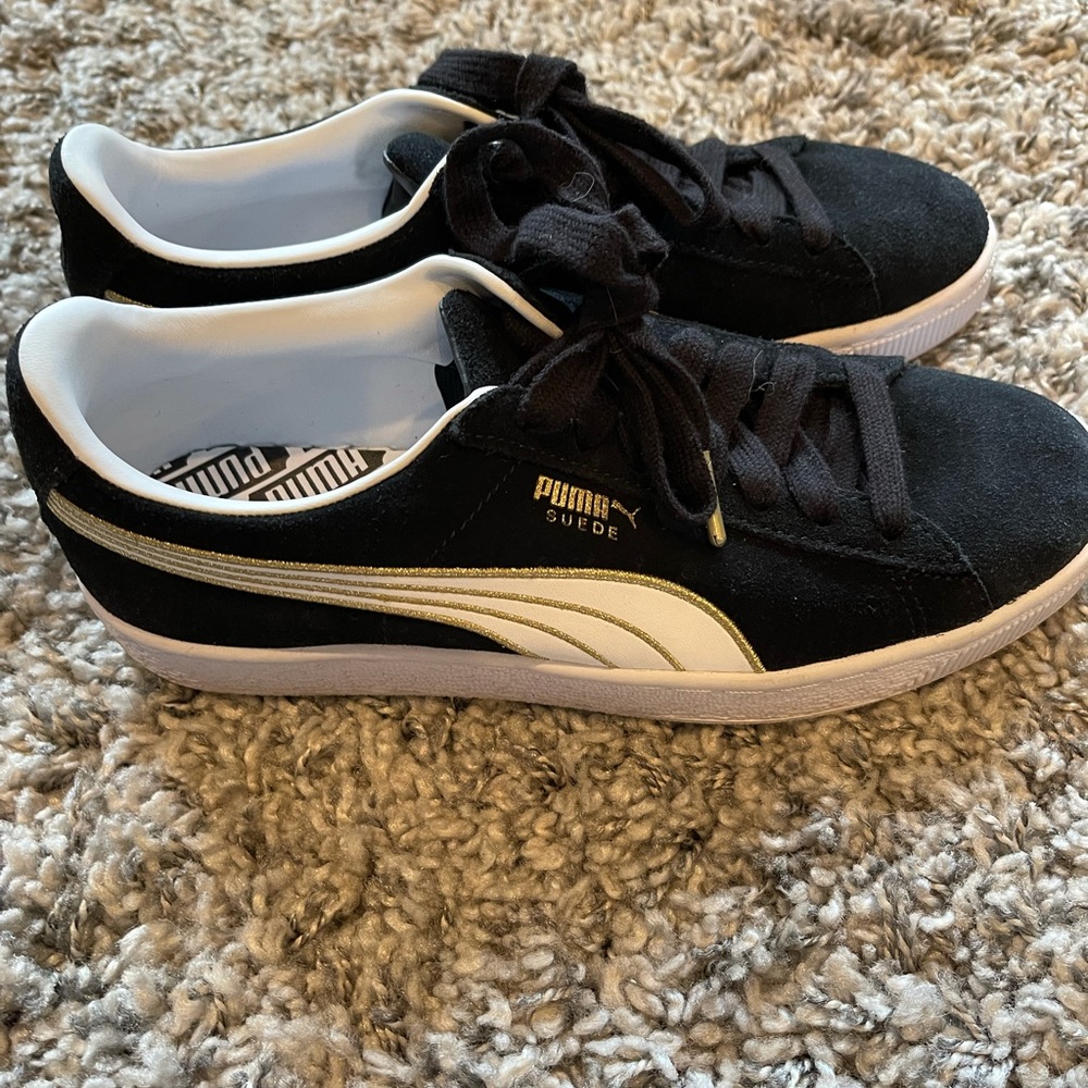 Black suede and gold Puma sneakers